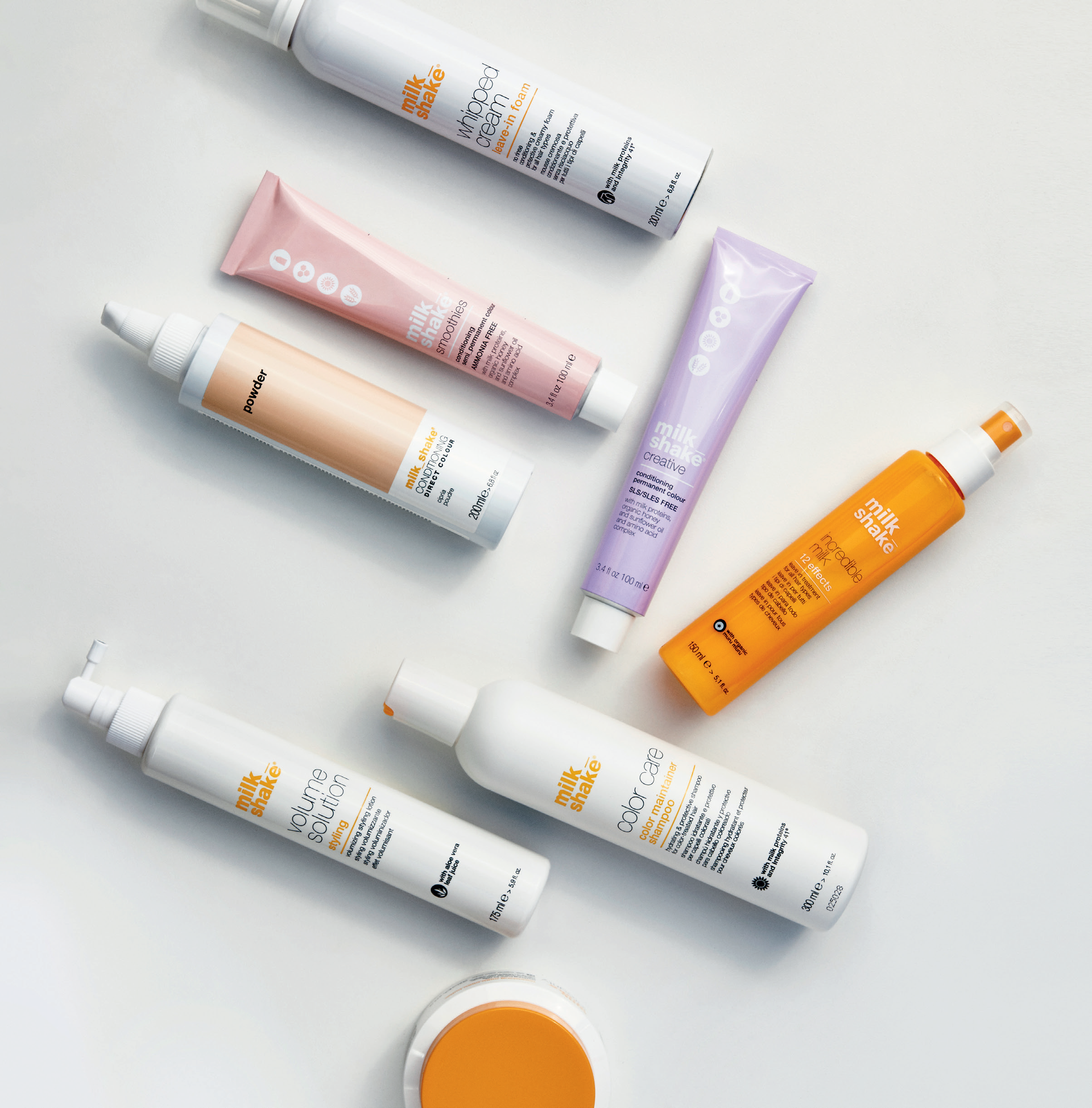 A bunch of bottles and tubes with one that says ' lotion ' on it