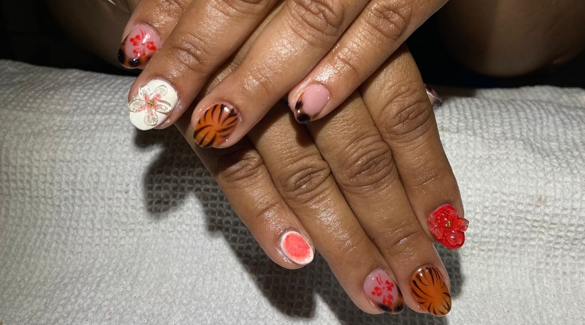 A close up of a person 's nails with different designs on them.