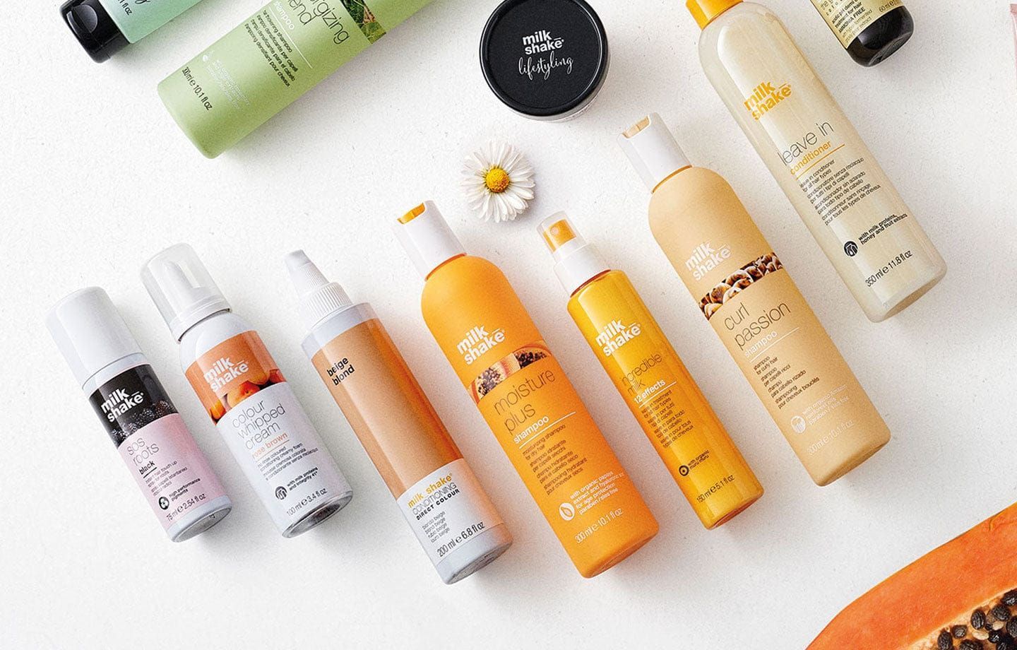A bunch of bottles of cosmetics are sitting on a table.