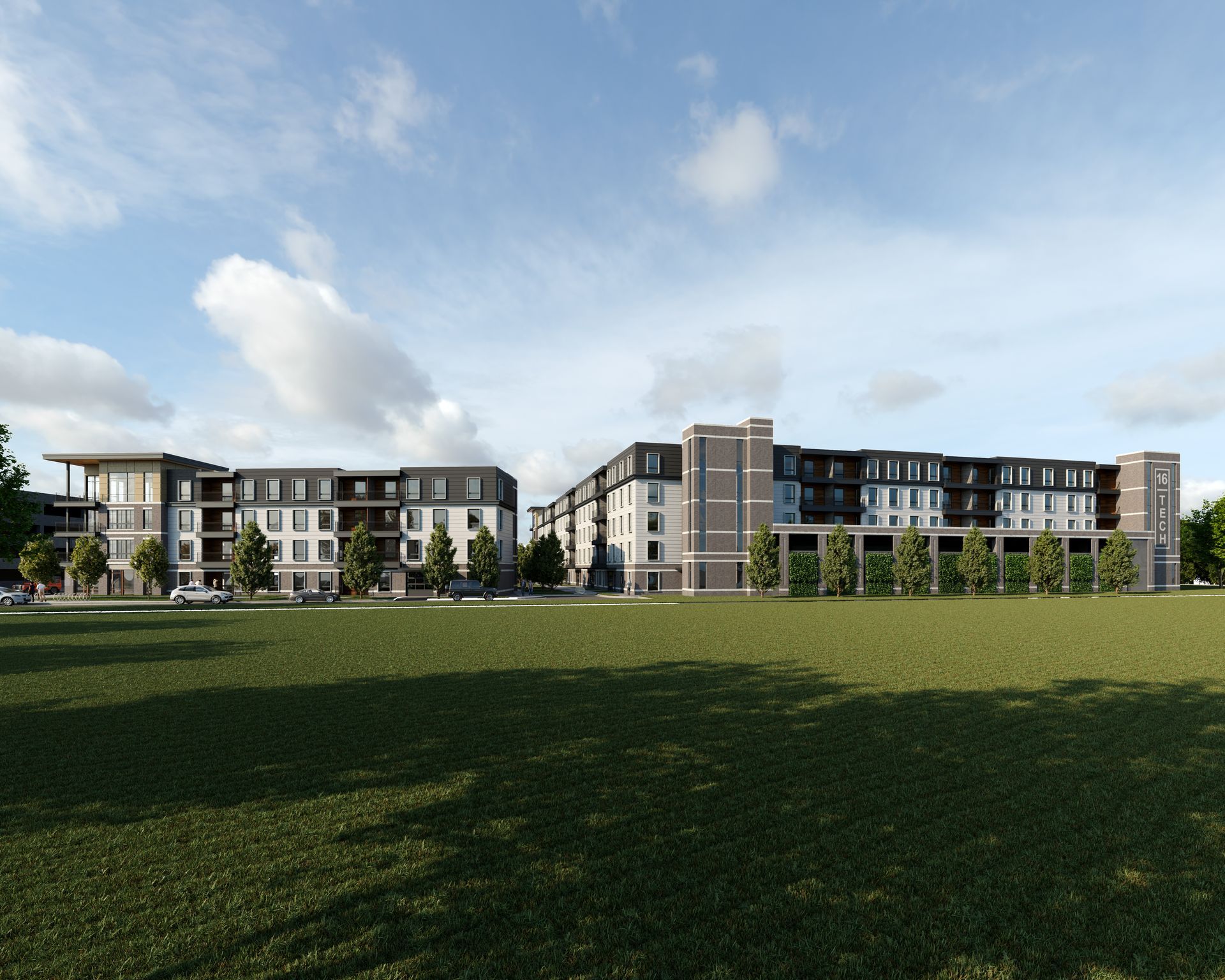 a large apartment building next to a grassy field at Vanguard at 16 Tech in Indianapolis, IN.