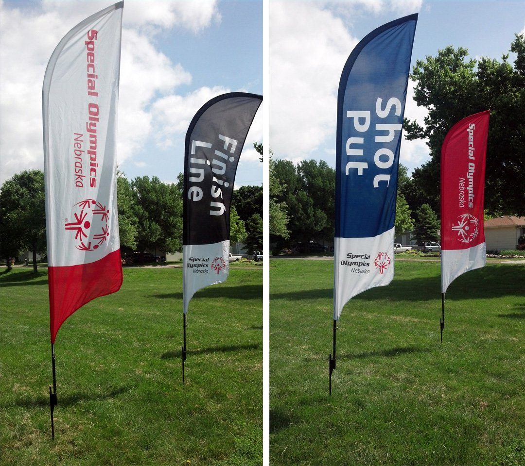 A row of flags with one that says shot put on it