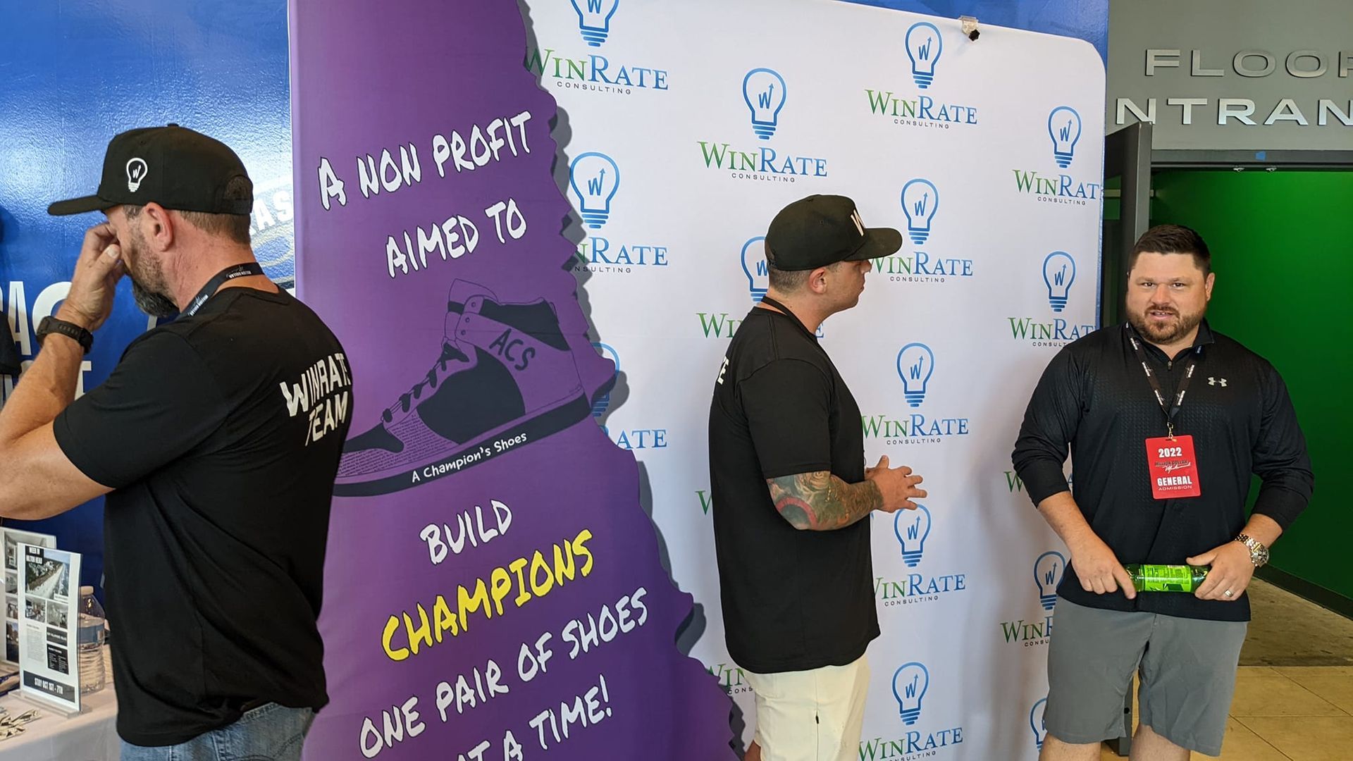 A group of men standing in front of a sign that says build champions