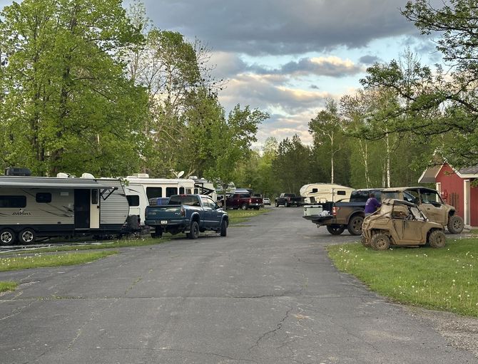 Vehicles parked at the Trails Inn Quadna RV Campground. An image of RVs, Trucks, and SxSs at the Trails Inn Quadna RV Campground.