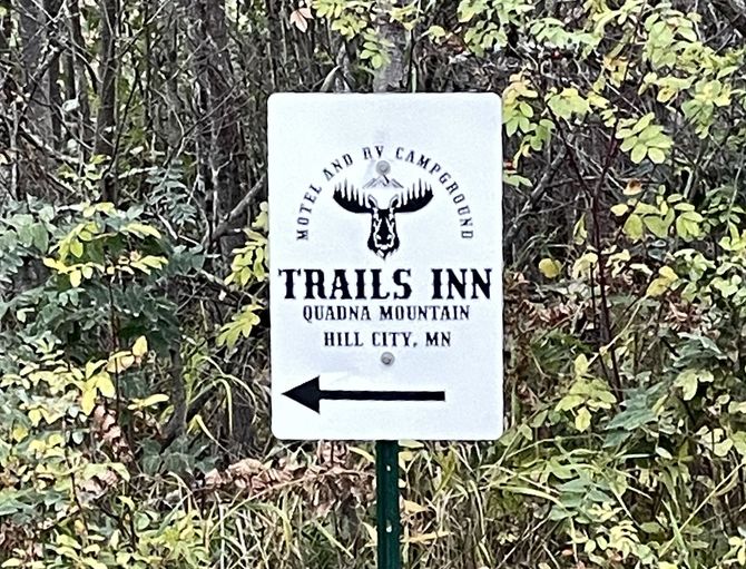The directional trails sign for Trails Inn Quadna Mountain Motel and RV Campground. The trails sign with directional arrow for Trails Inn Quadna Mountain Motel and RV Campground in Hill City, MN.