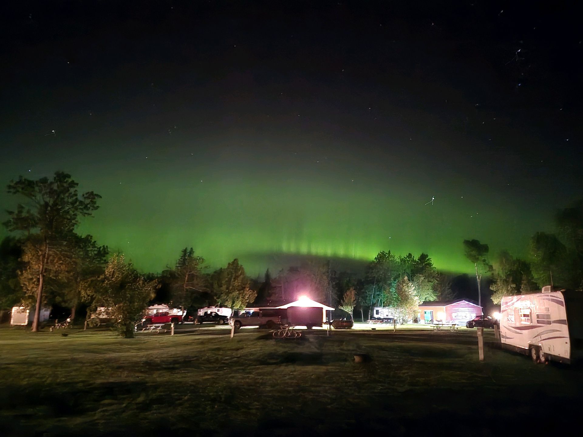 A Northern Lights Image Over Trails Inn Quadnand bathhouse. A Northern Lights Image Over Trails Inn Quadna Mountain RV Campground.