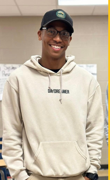 a man wearing a hoodie that says daydreamer on it