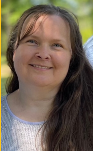 a woman with long brown hair is smiling for the camera .