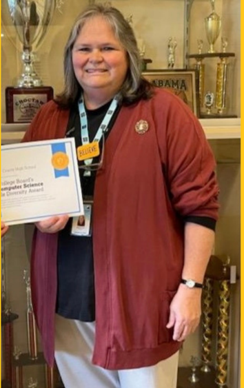 a woman in a maroon jacket is holding a certificate