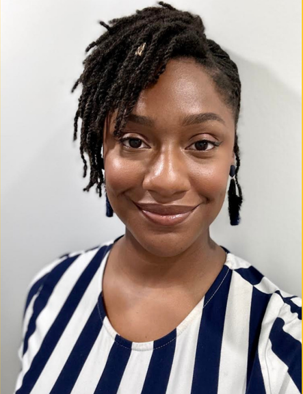 a woman with dreadlocks is wearing a blue and white striped shirt