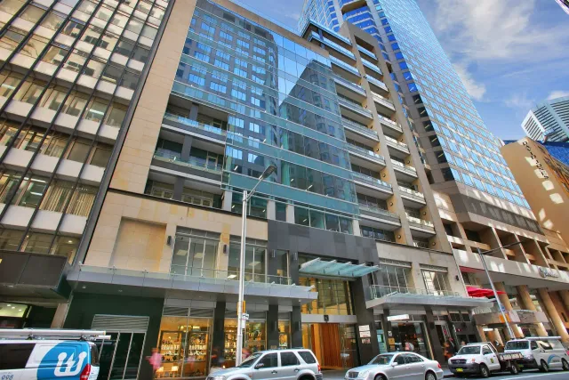 A large building with cars parked in front of it