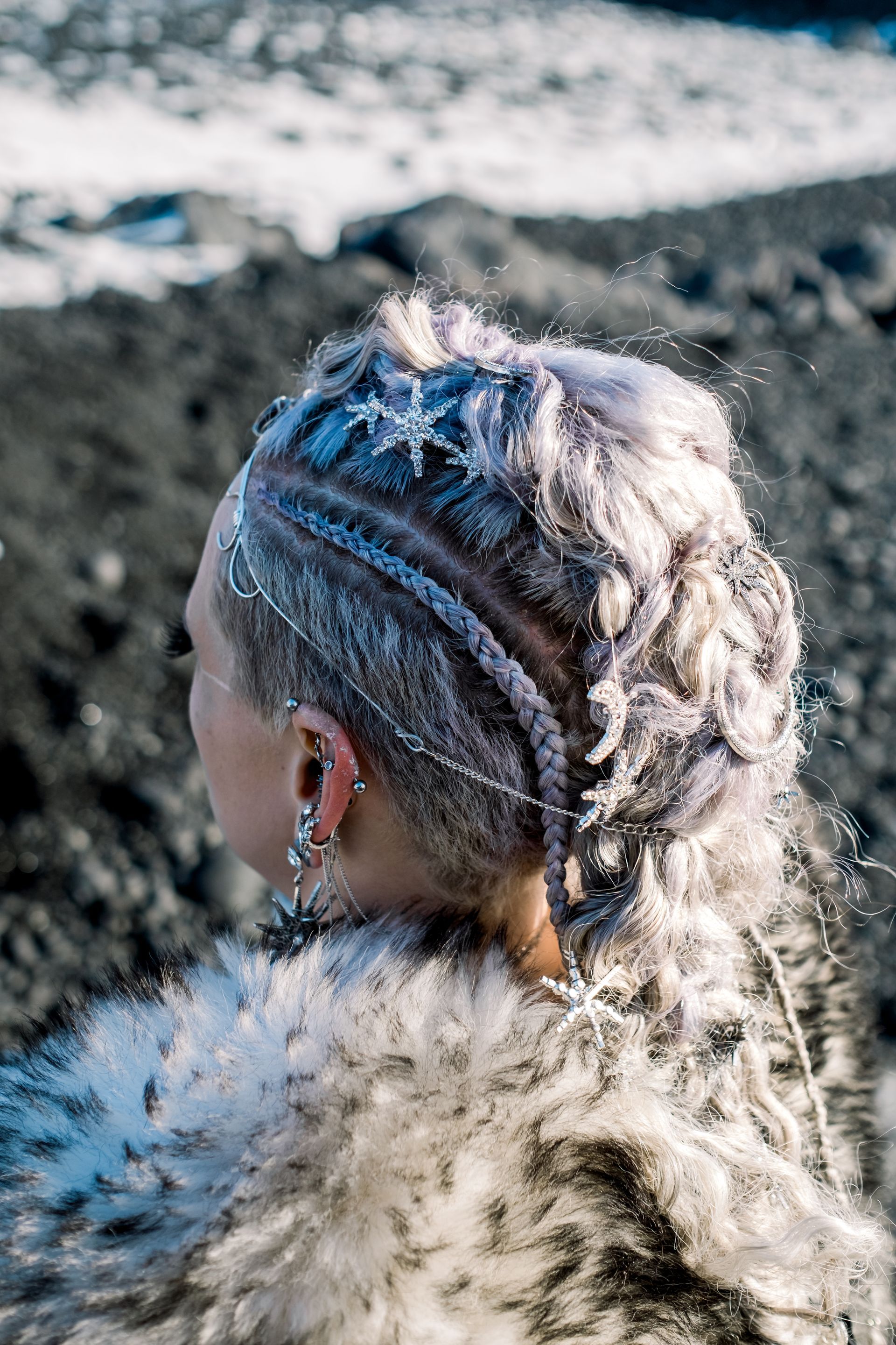 The woman is wearing a fur coat and has a braid in her hair.
