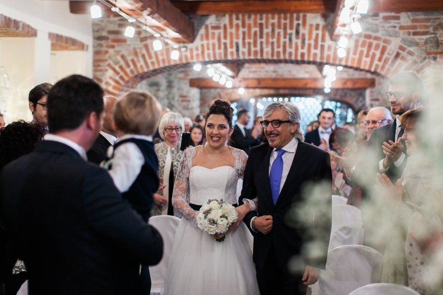 A bride and groom are walking down the aisle at their wedding.