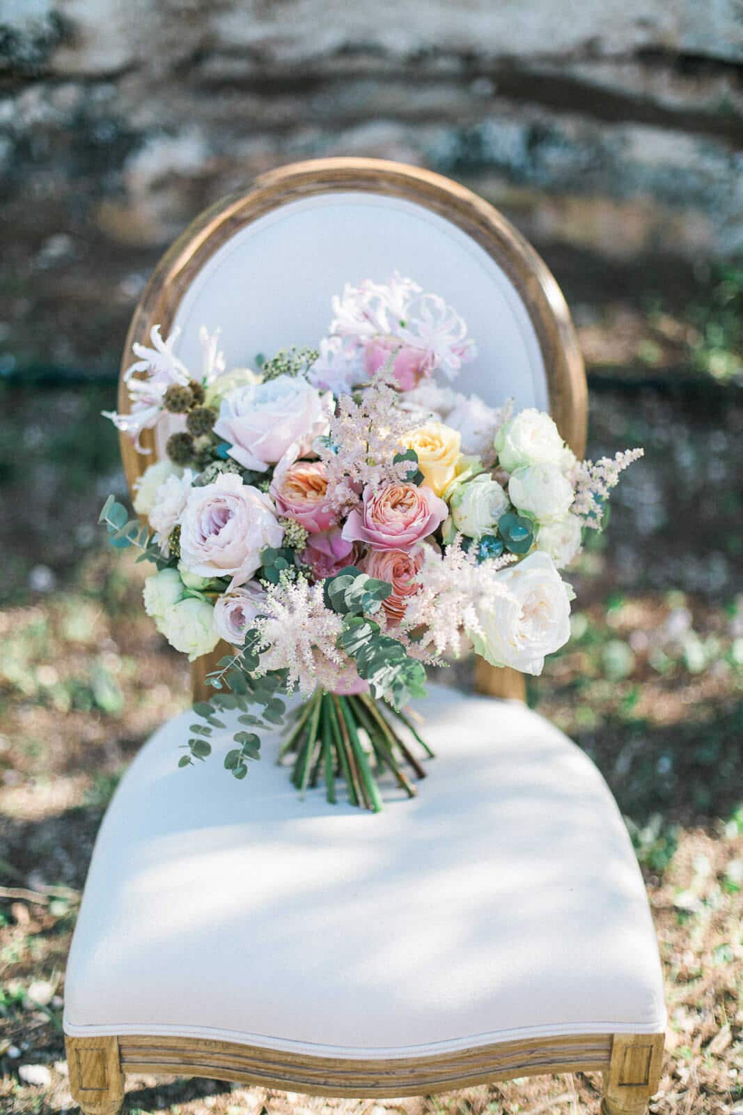 A bouquet of flowers is sitting on a chair.