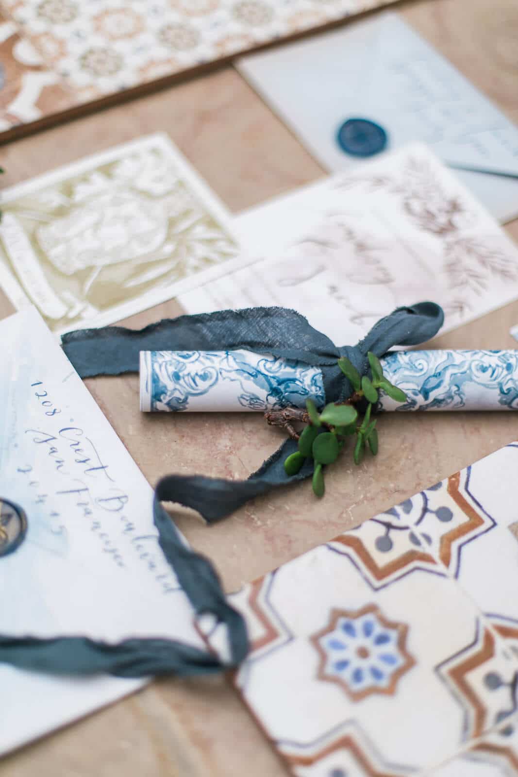 A roll of paper with a ribbon tied around it is sitting on a table.