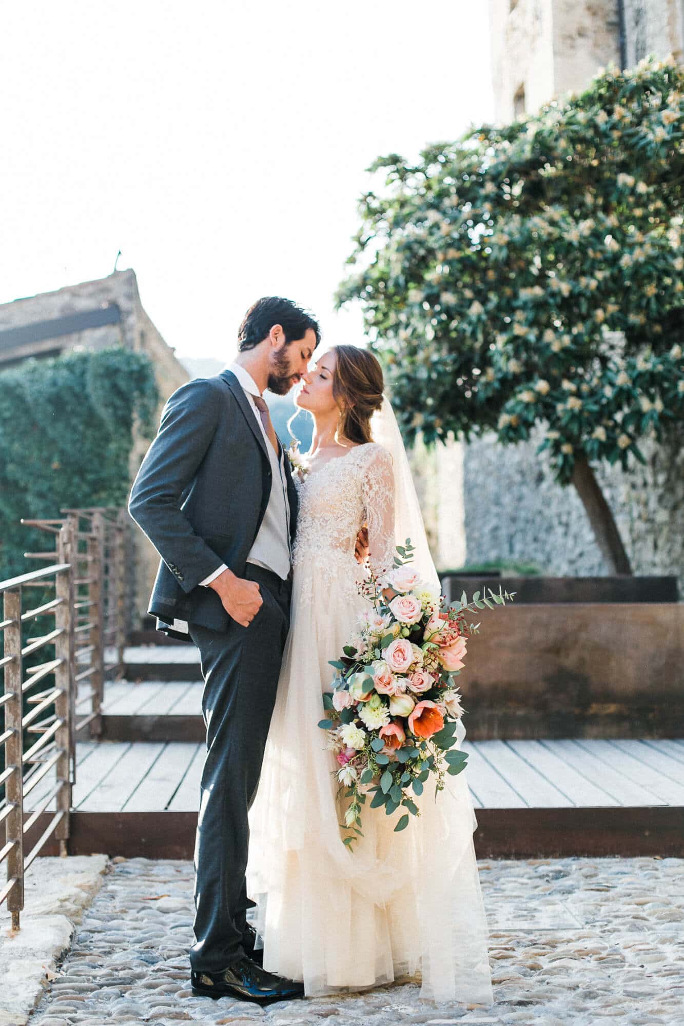 A bride and groom are posing for a picture on their wedding day.