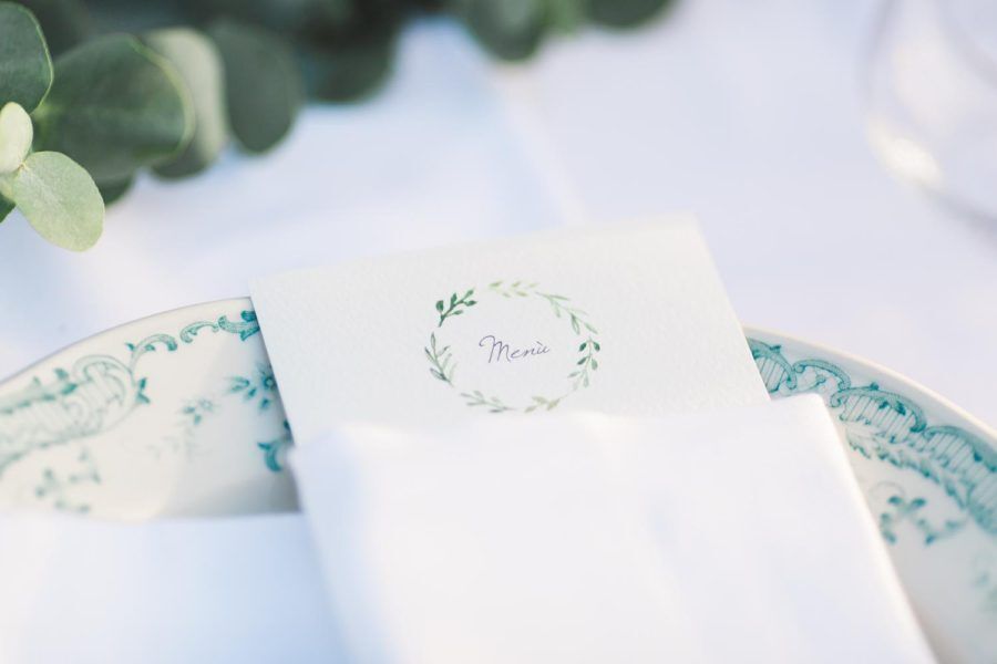 A napkin is sitting on top of a plate on a table.