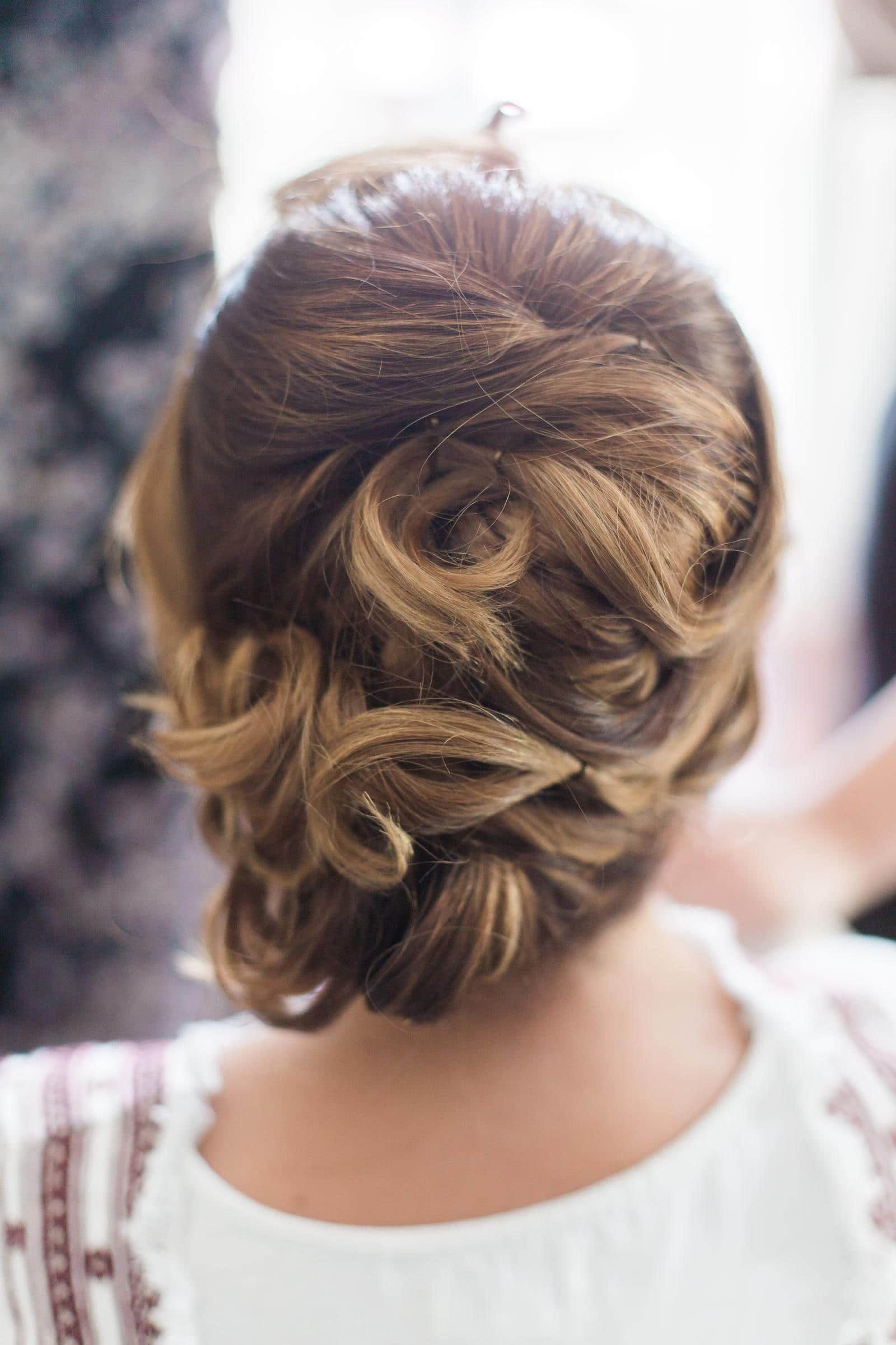 A close up of a woman 's hair in a bun.