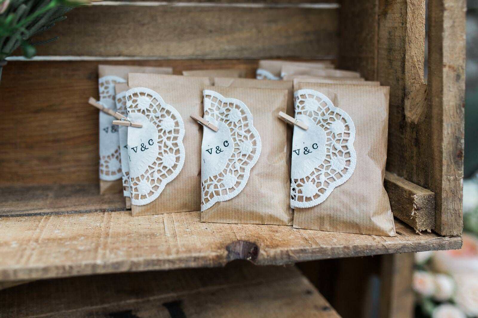 A wooden shelf with three bags of seeds on it.