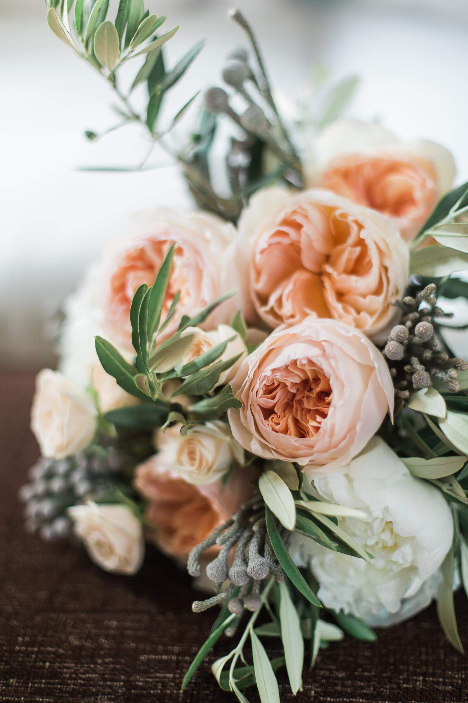 A close up of a bouquet of flowers on a table.