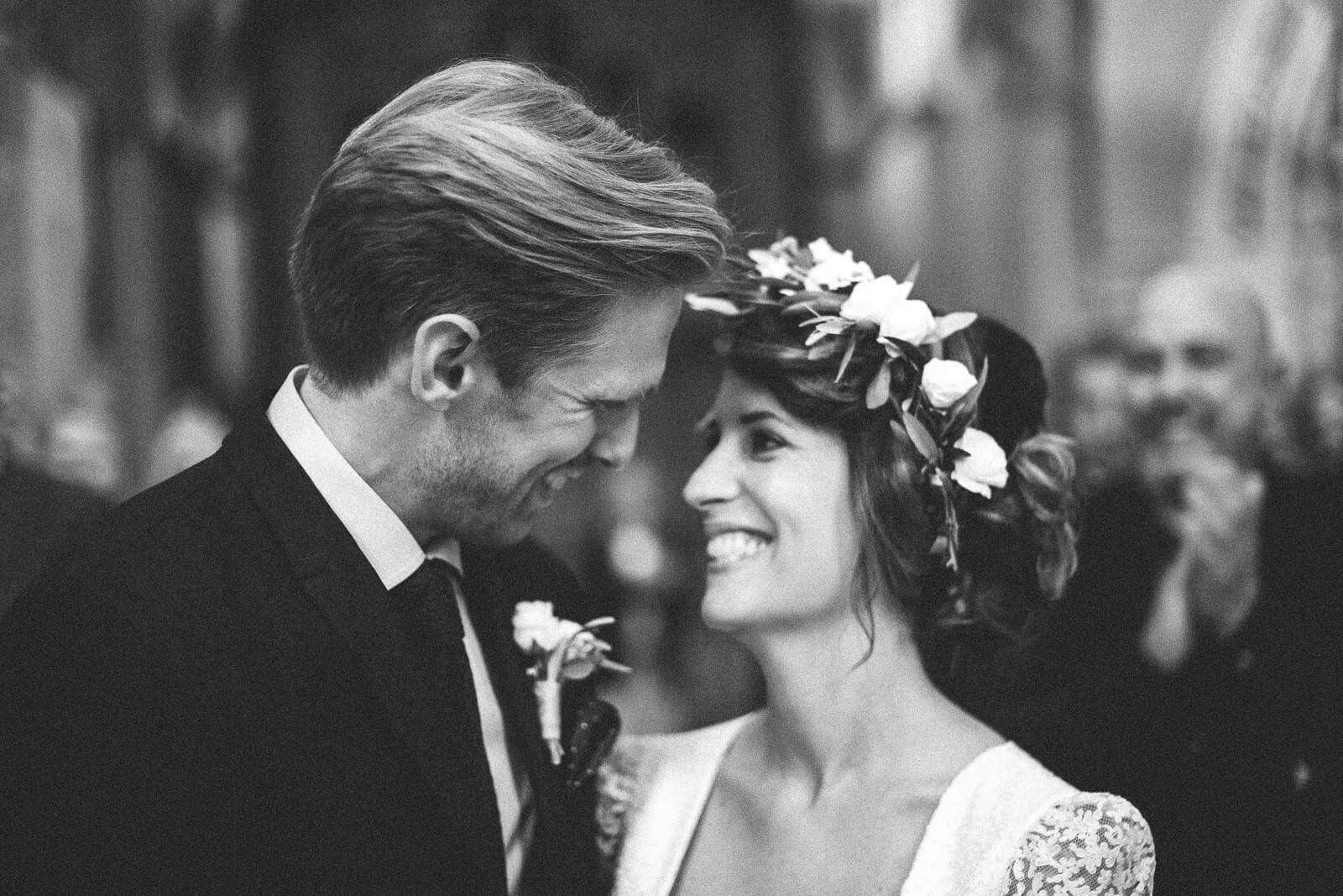A black and white photo of a bride and groom looking at each other.