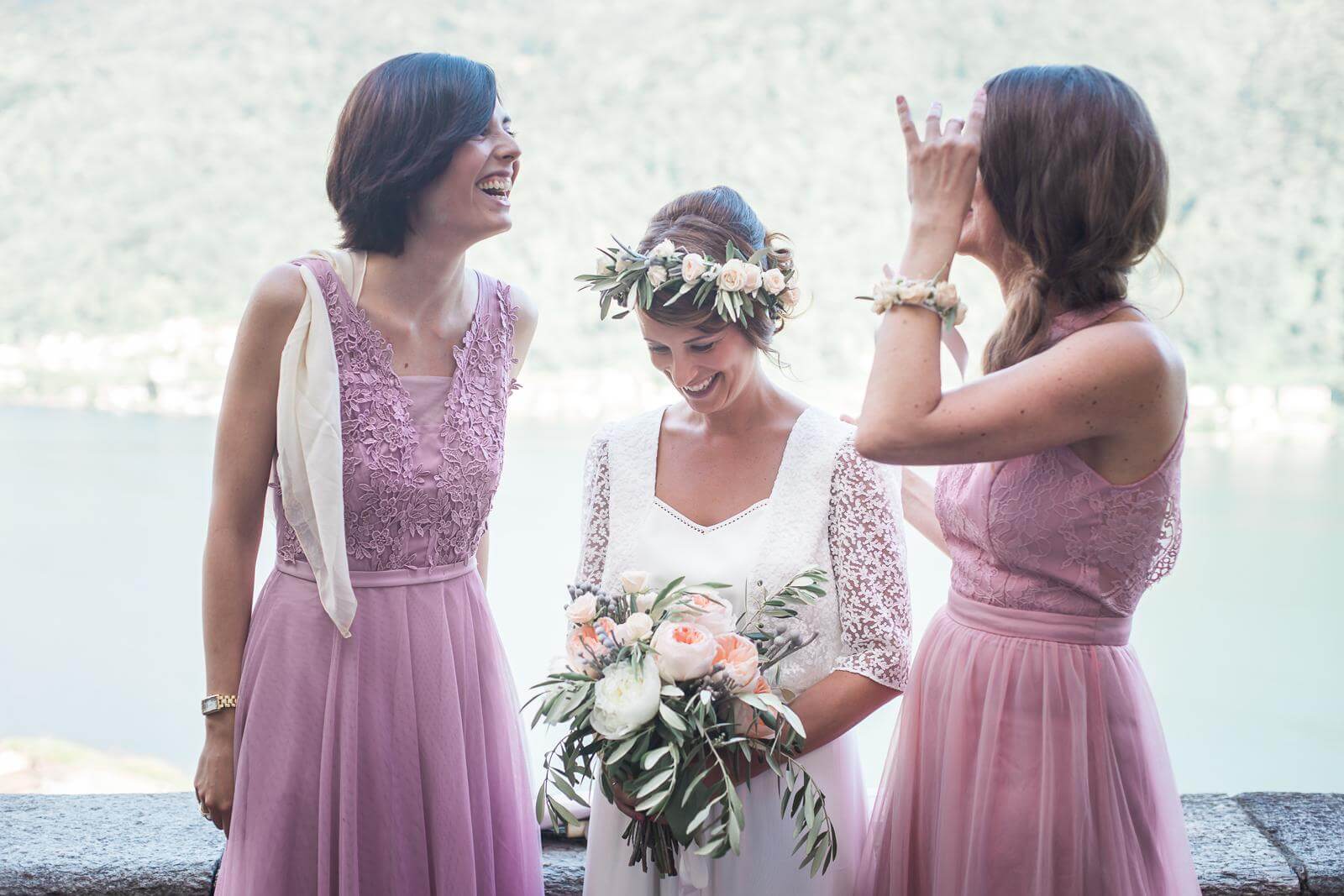 A bride and her bridesmaids are standing next to each other and laughing.