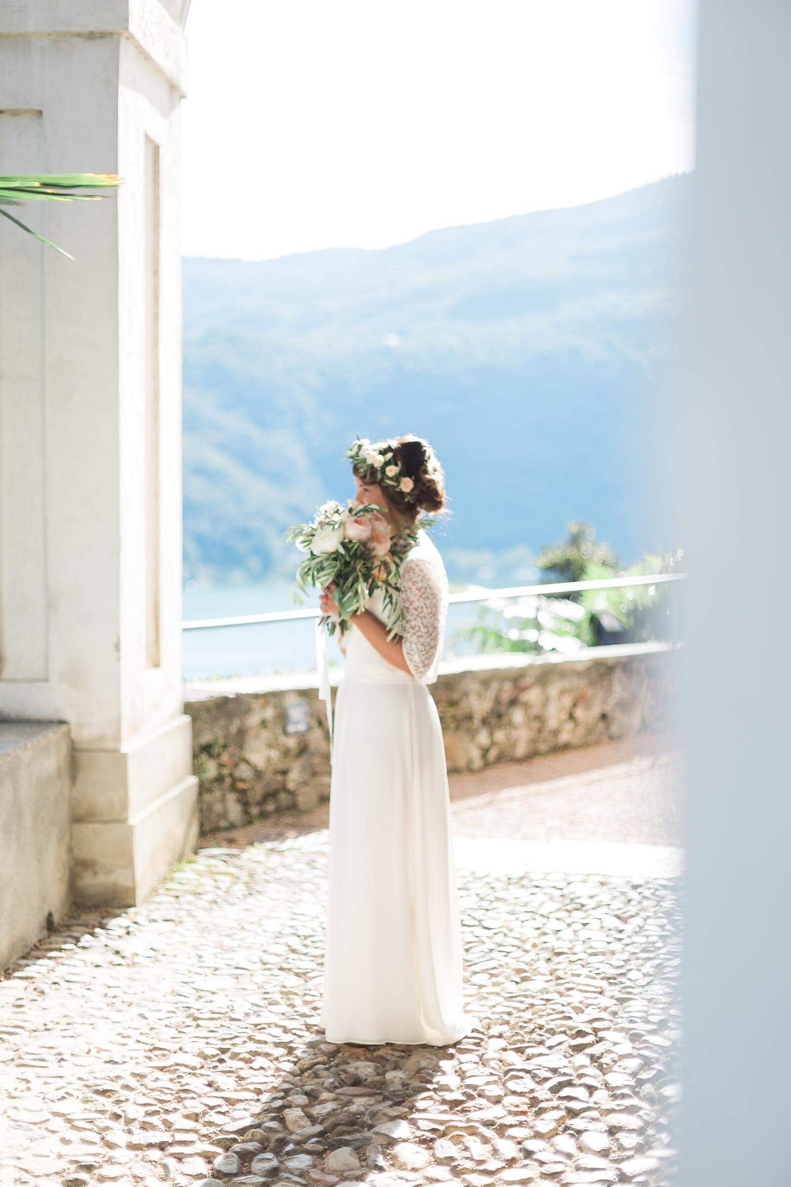 A bride in a white dress is holding a bouquet of flowers.