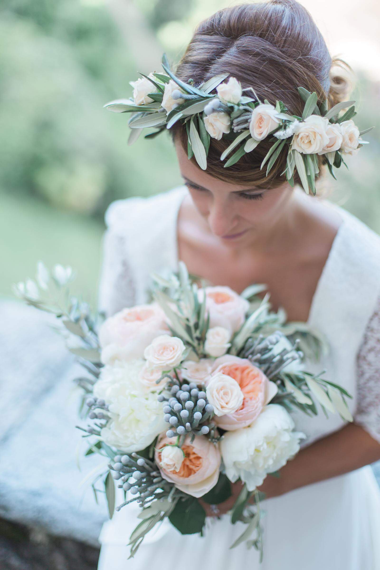 The bride is wearing a flower crown and holding a bouquet of flowers.