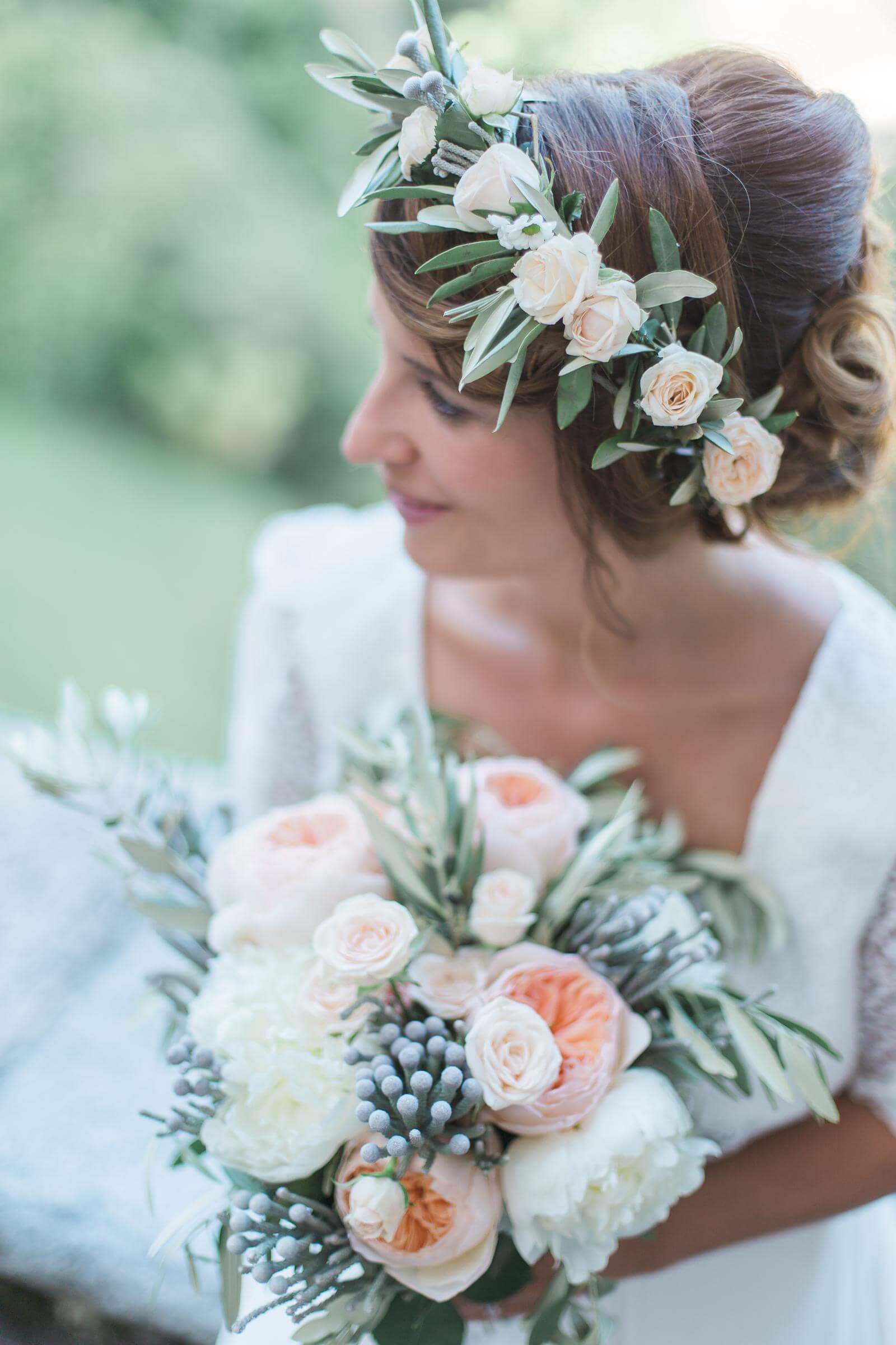 The bride is wearing a flower crown and holding a bouquet of flowers.