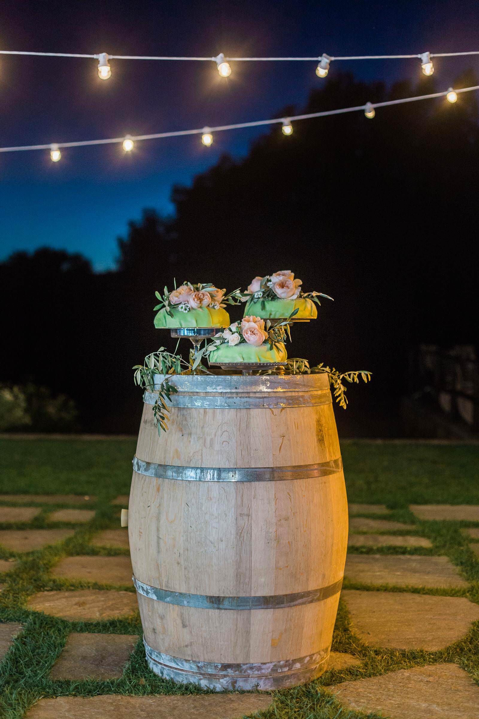 A wooden barrel with a cake on top of it.