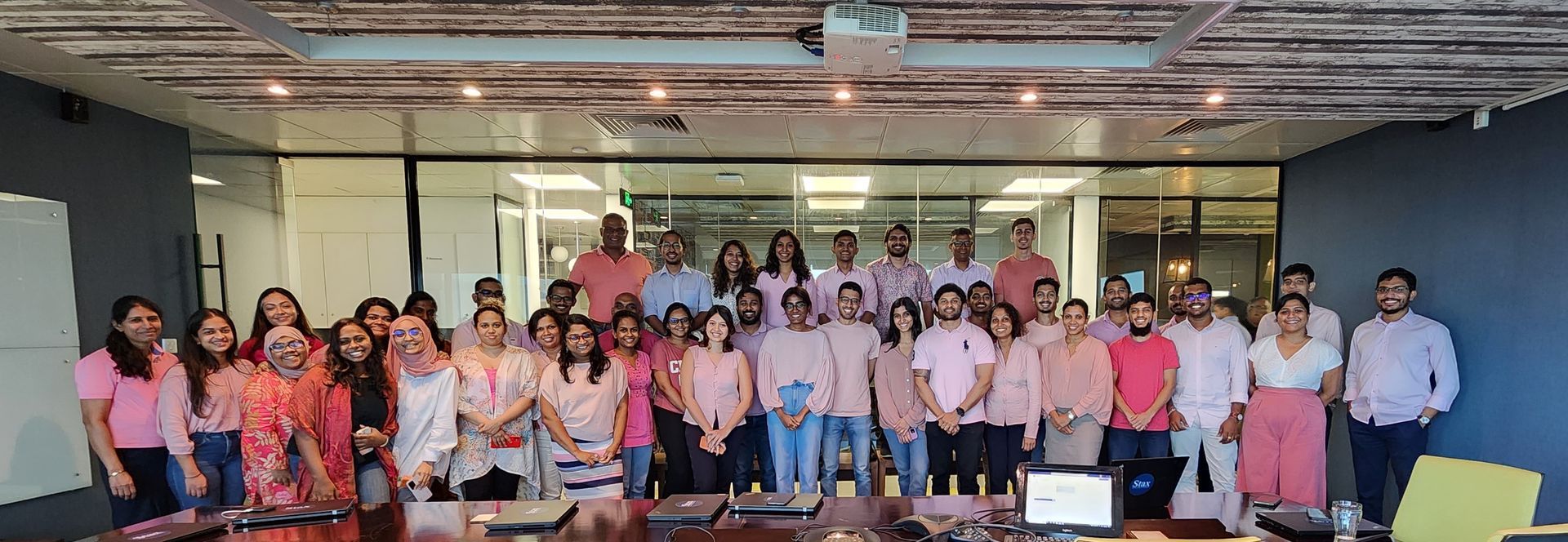 Stax Colombo gather for a photo to celebrate Pink Week