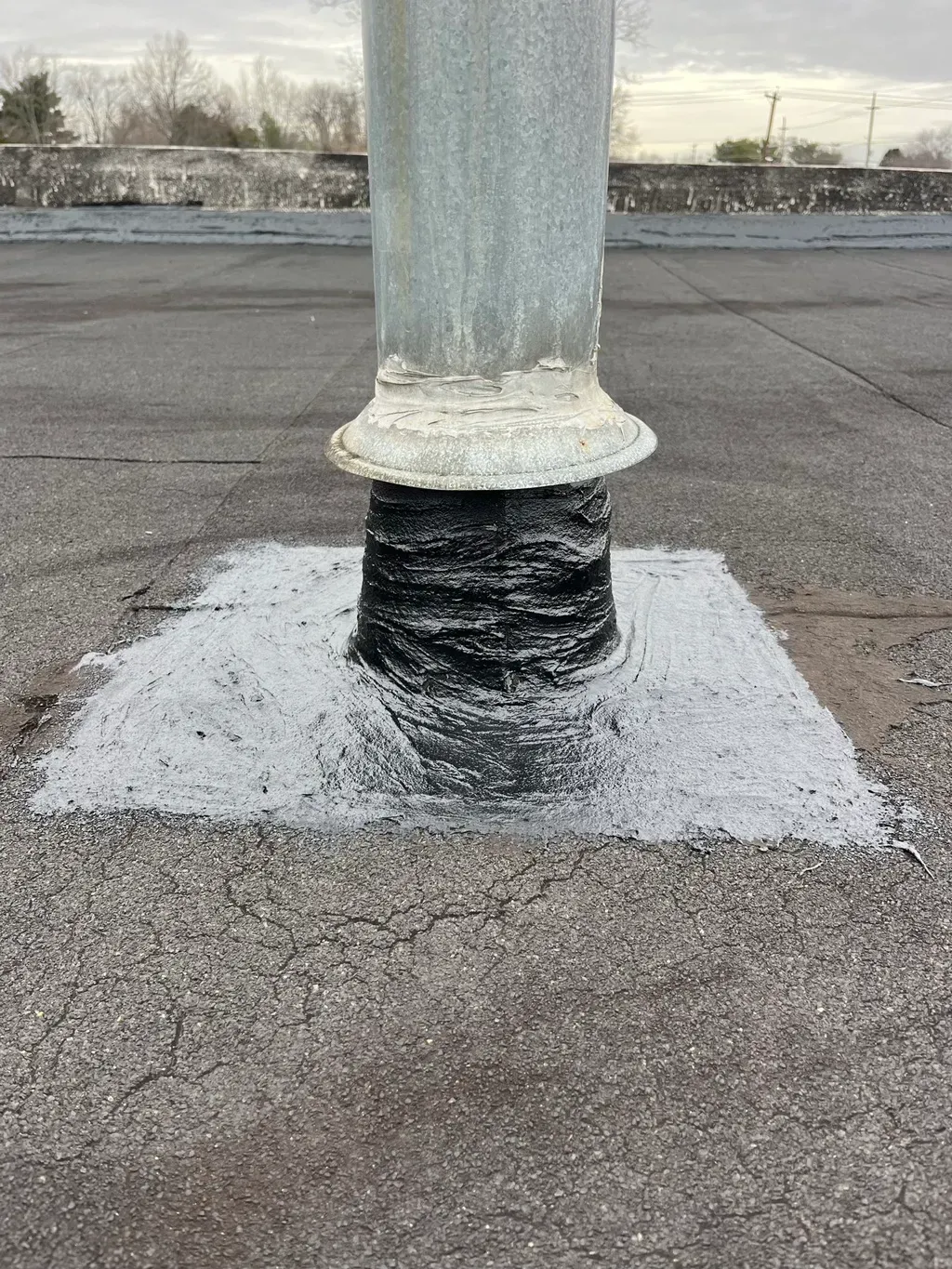 A pole is sitting on top of a concrete surface.