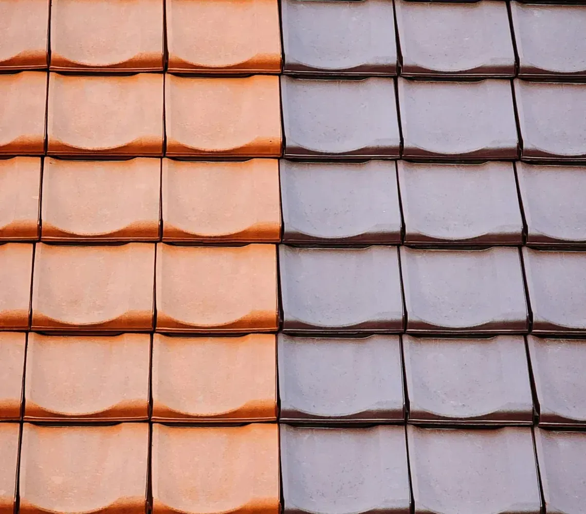 Orange and gray roof tiles arranged in vertical rows, divided down the middle by color.