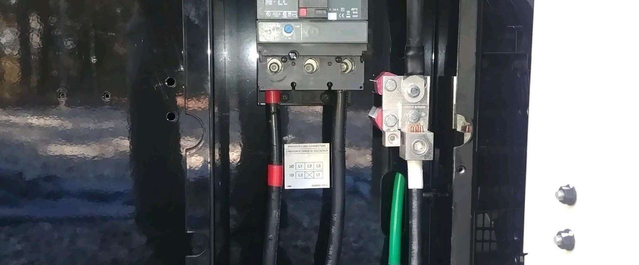 A close up of a electrical box with wires coming out of it.