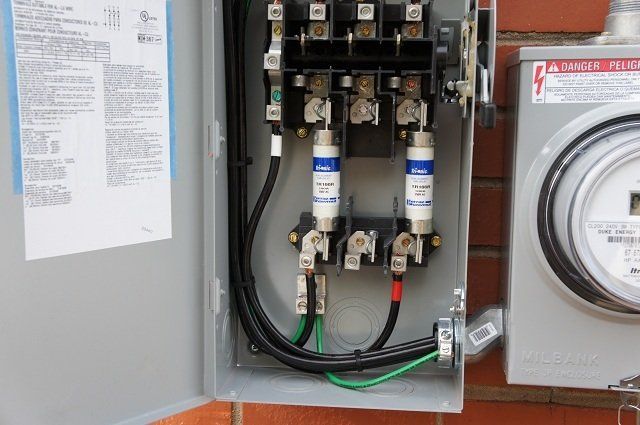 A close up of an electrical box with a meter attached to it.