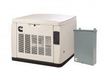 A generator is sitting next to a box on a white background.