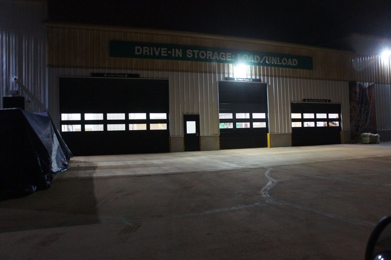 A drive in storage facility is lit up at night