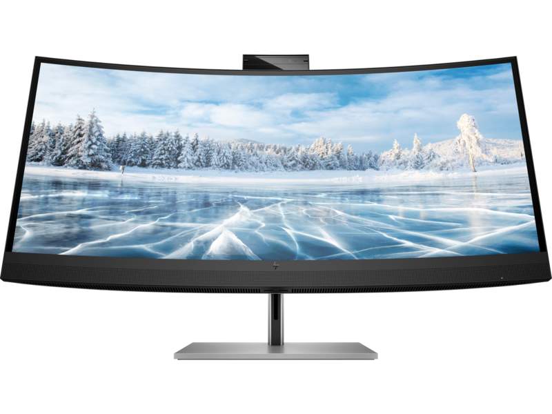 Écran incurvé affichant un paysage hivernal avec neige et glace, sur un support noir.