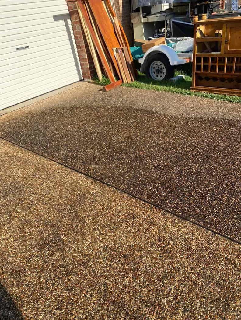 A Trailer Is Parked In A Driveway Next To A Garage Door — Gibbo’s Lawns & Property Maintenance In Salamander Bay, NSW