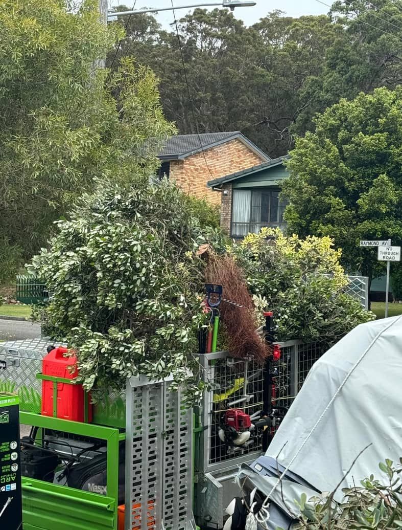 A Green Truck Is Parked In Front Of A House — Gibbo’s Lawns & Property Maintenance In Salamander Bay, NSW