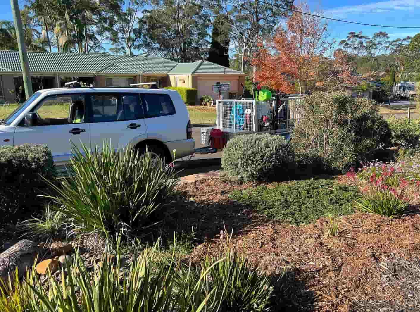 A White Van Is Parked In Front Of A House In A Garden — Gibbo’s Lawns & Property Maintenance In Salamander Bay, NSW