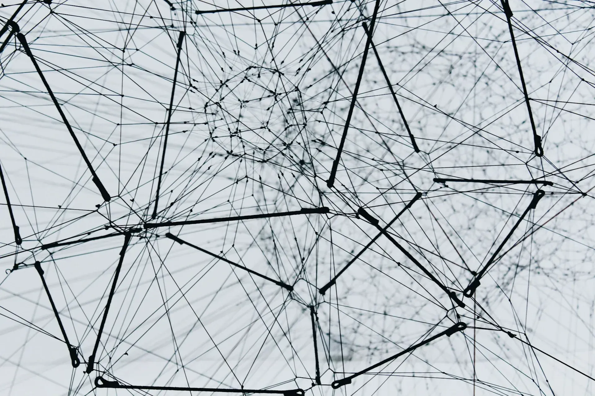 A black and white drawing of a spider web on a white background.