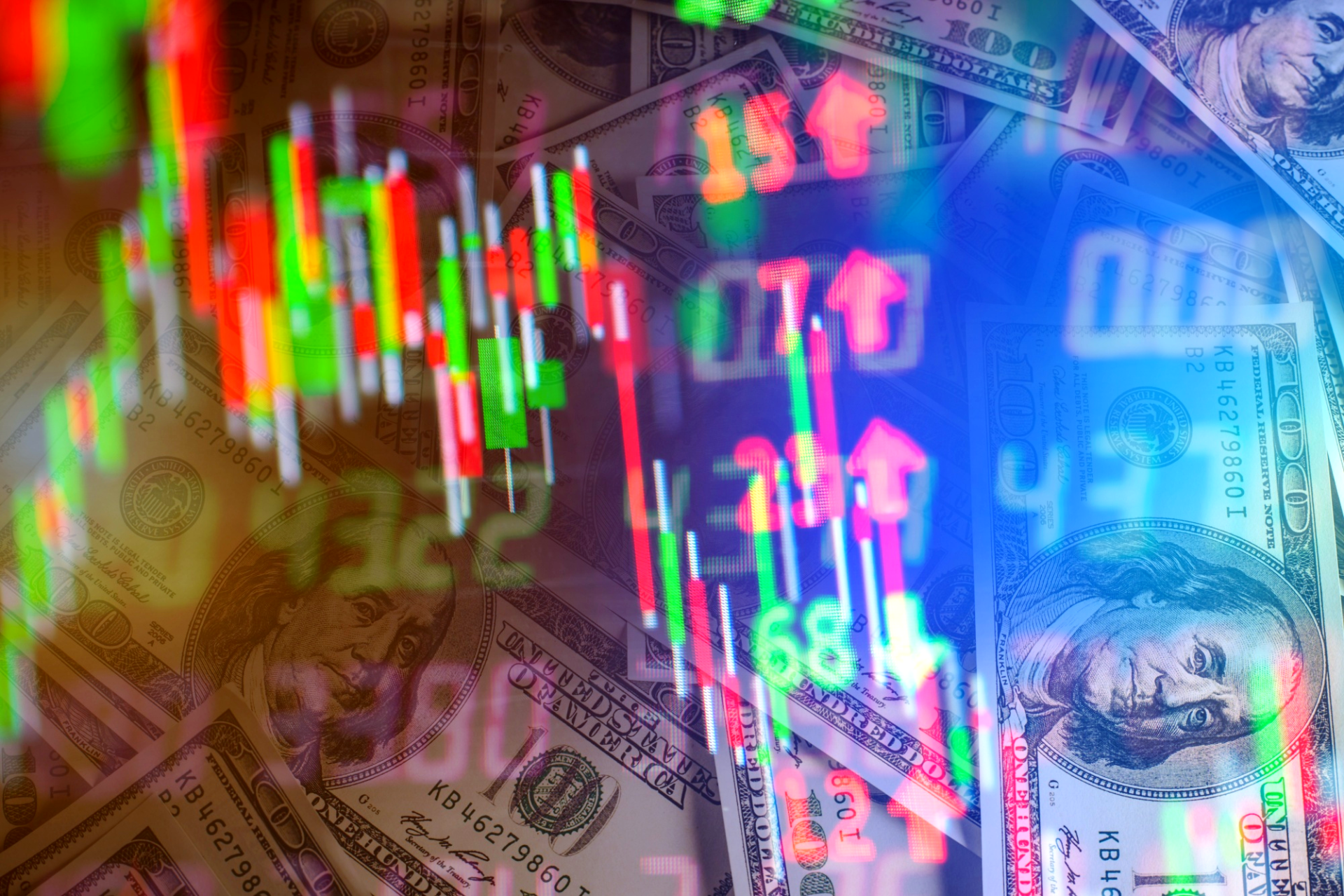 A bunch of money is sitting on top of a table with a stock chart in the background.