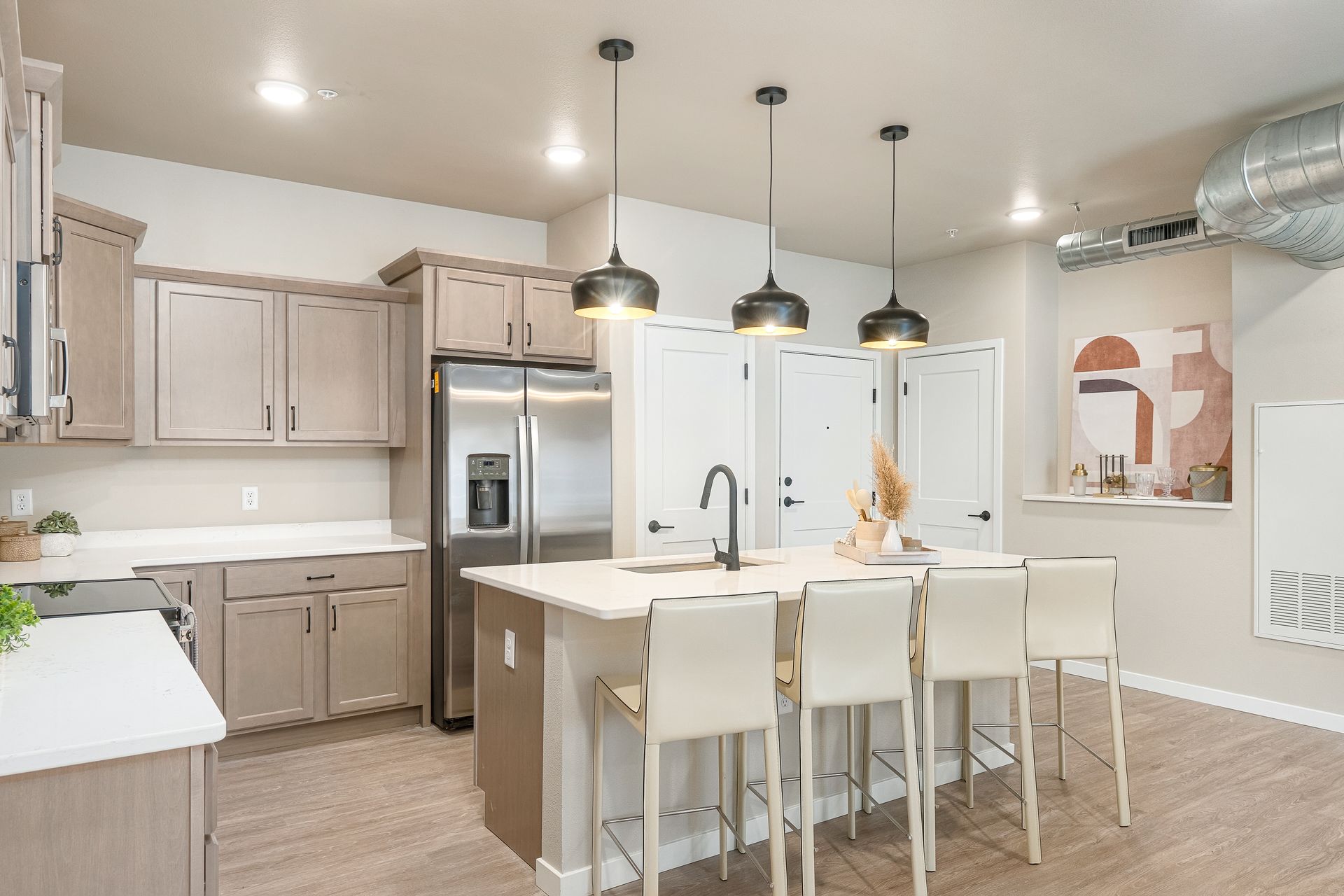 A kitchen with stainless steel appliances and a large island.