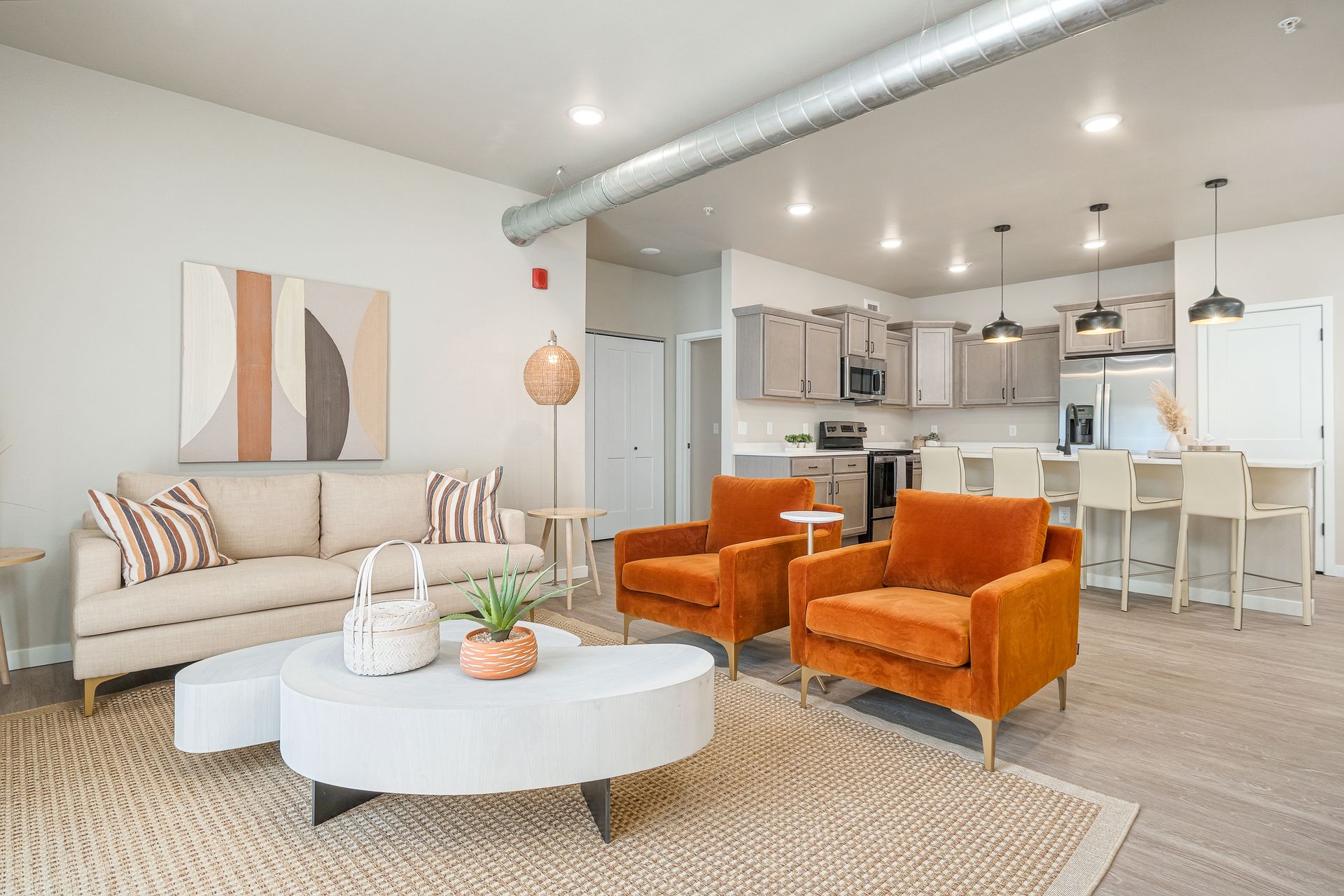 A living room with a couch , chairs , and a table.