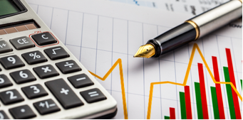 Calculator and pen on financial charts with red, green, and yellow bars.