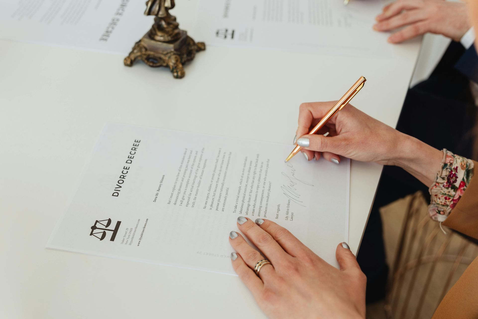 Woman Working With Family Law Attorney, Signing Divorce Documents