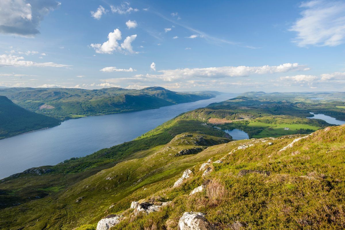 A view of a lake from the top of a mountain.