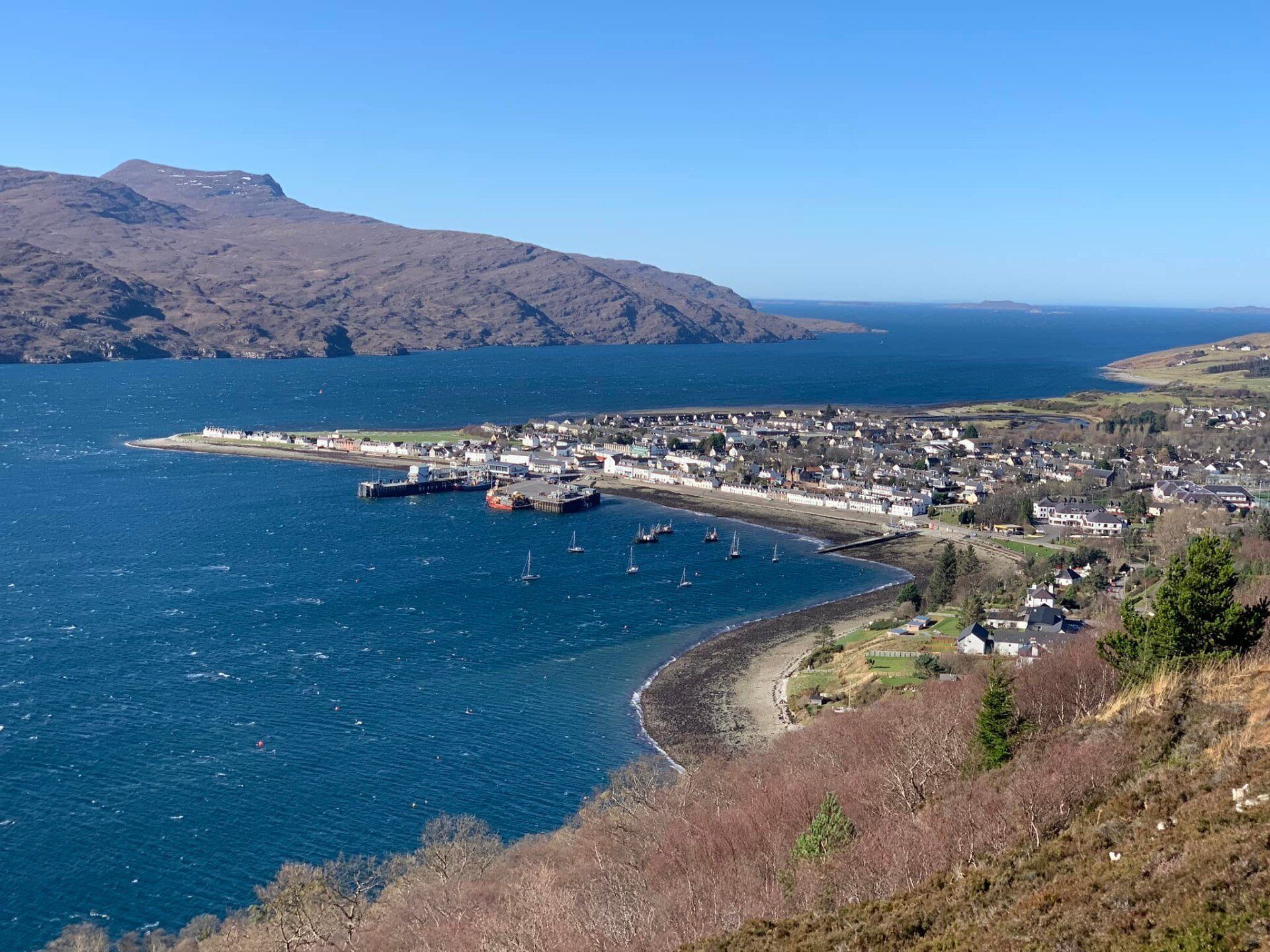A small town sits on the shore of a large body of water