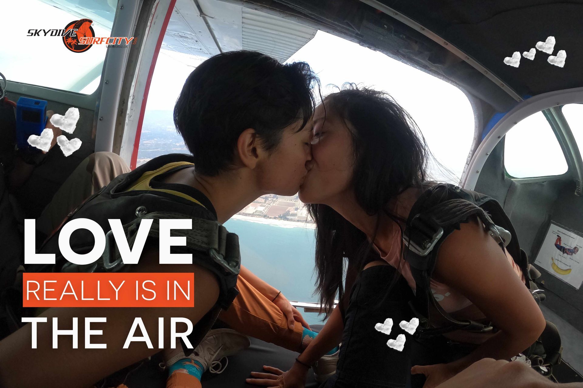 Two Skydive Santa Cruz customers kissing in an airplane before their skydive.
