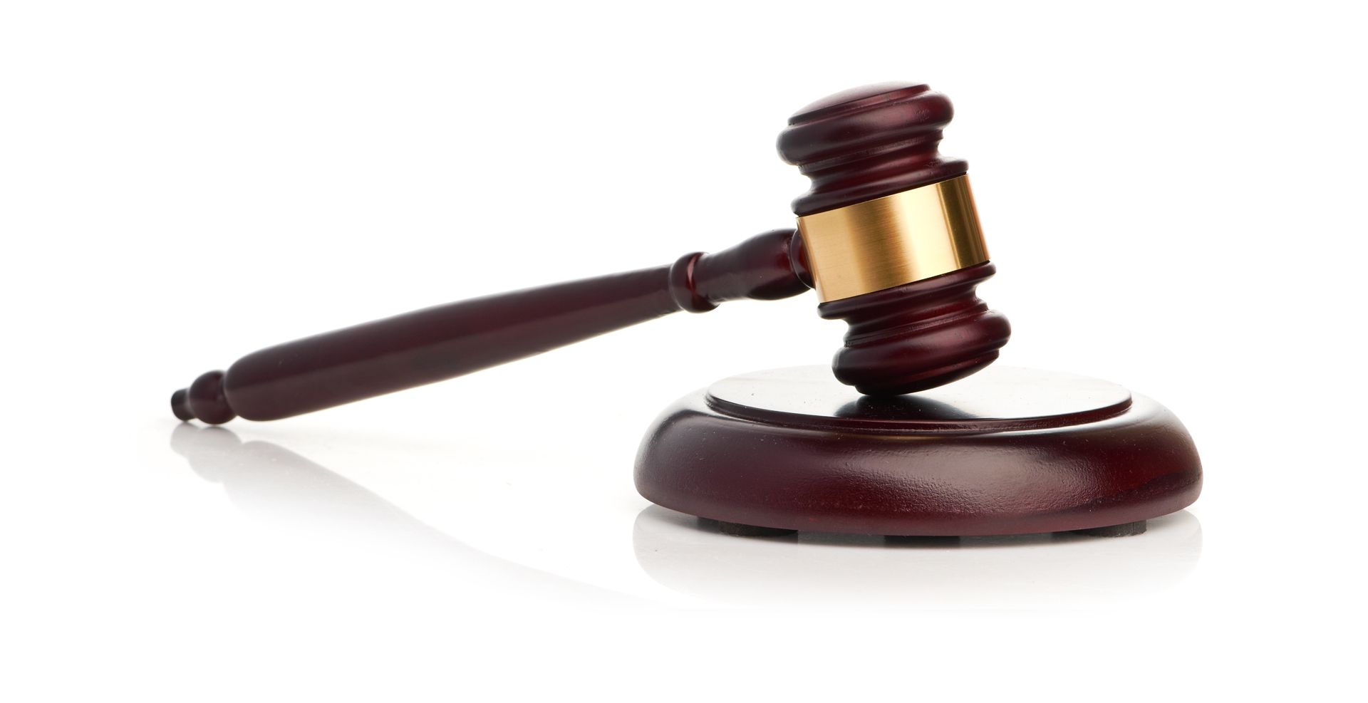 A Wooden Judge 's Gavel is Sitting on a Wooden Base on a White Background